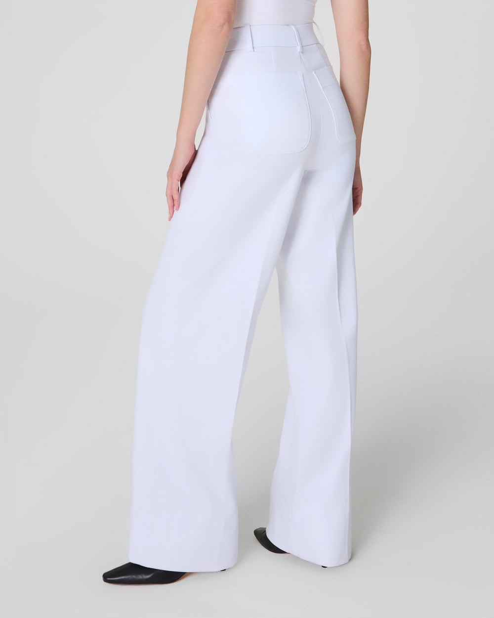 White Stretch Twill Wide Leg Pants by SPANX, showing the relaxed fit and high-rise design on a model.