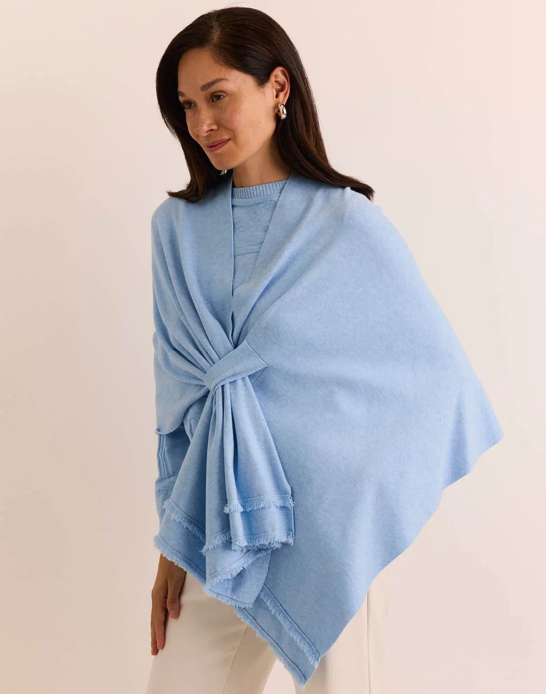 Woman wearing a light blue poncho the h edition Mabel Tab Fringe Wrap