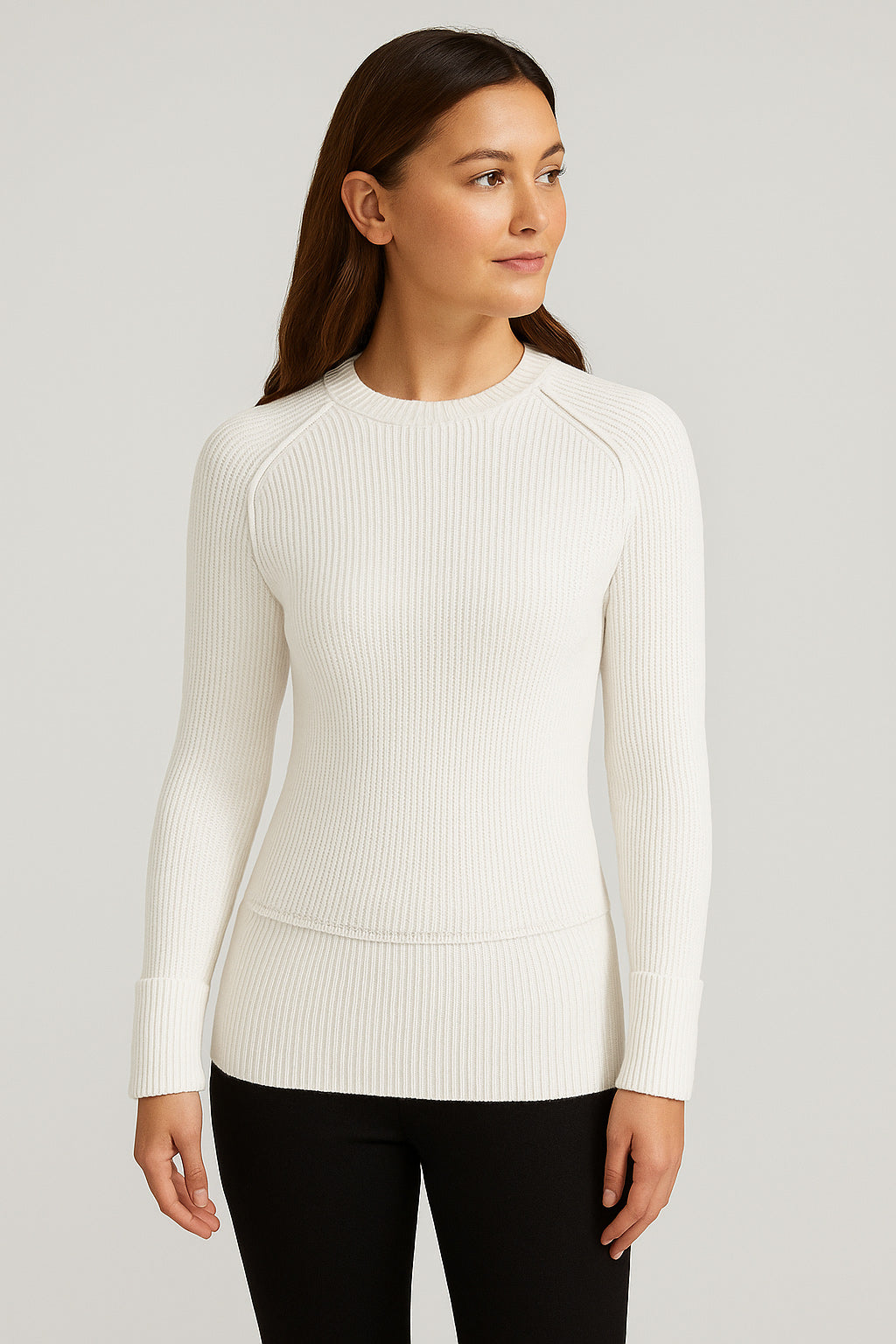 Woman wearing a white ribbed sweater against a light gray background
