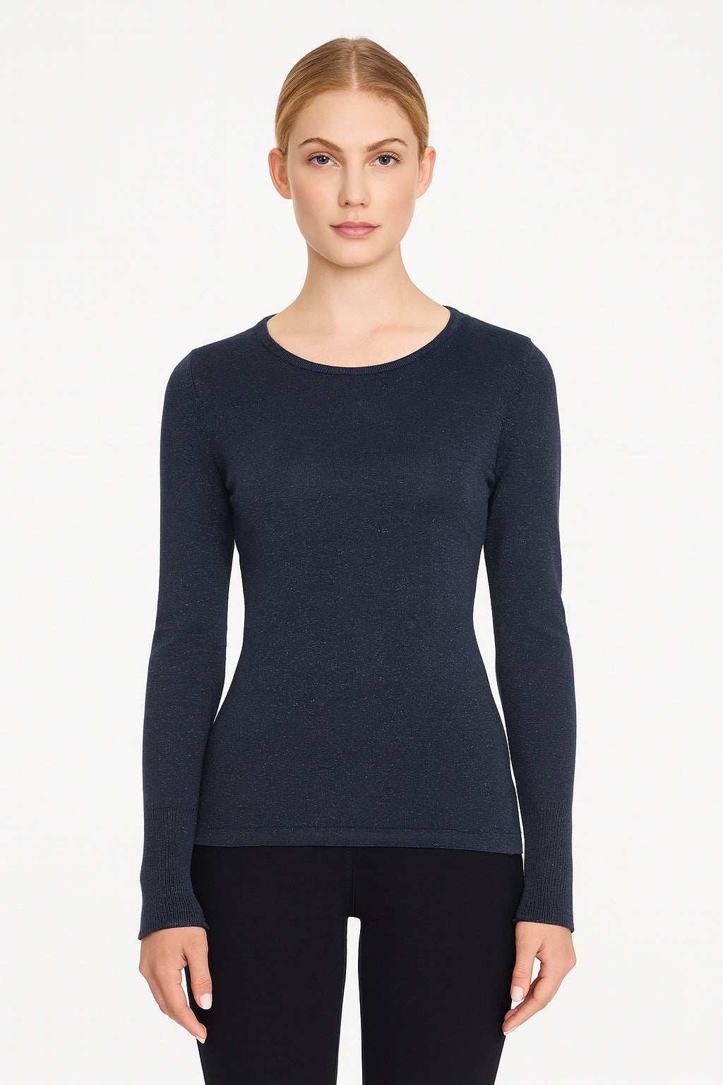 Woman wearing a navy long-sleeve top on a white background