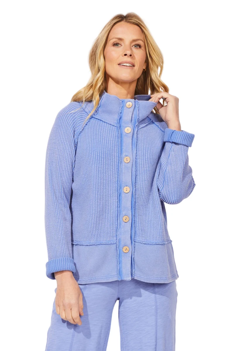 A woman modeling ESCAPE BY HABITAT MIXED WAFFLE MOCK NECK - 97011 Baja Blue a light blue ribbed knit cardigan with a high stand collar and button-front closure