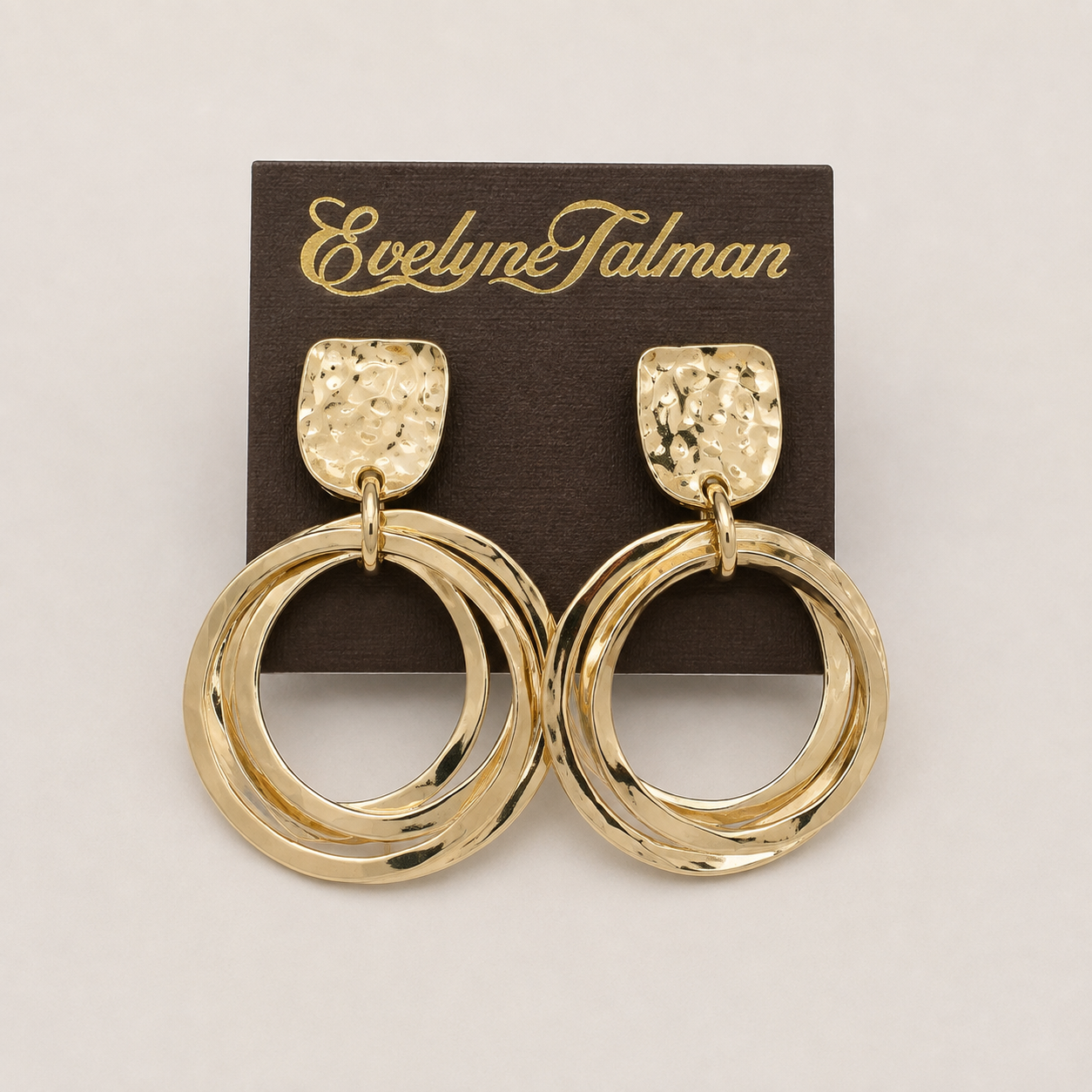 A pair of gold-tone double hoop drop earrings with textured square studs.