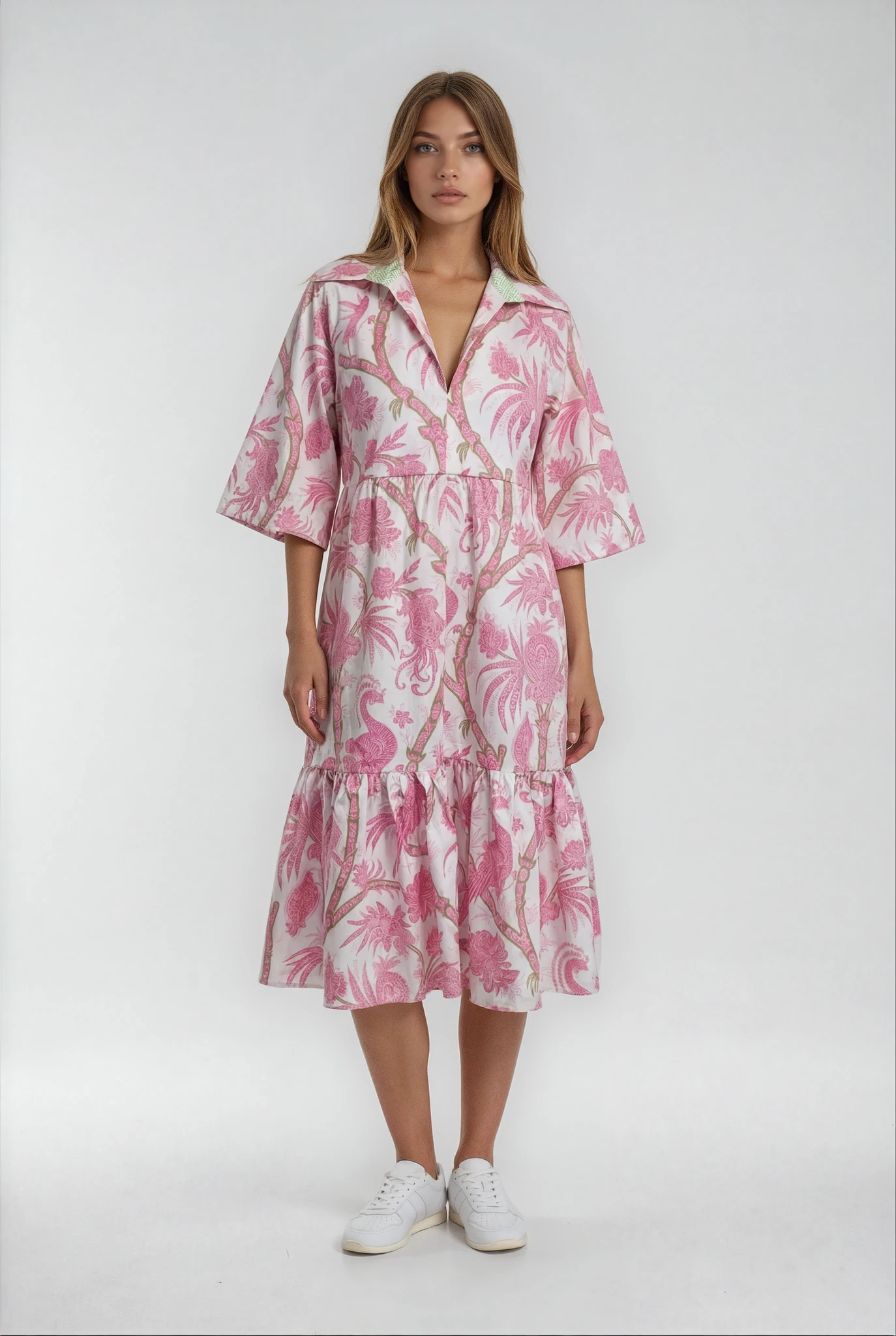 Woman wearing a pink floral dress on a white background