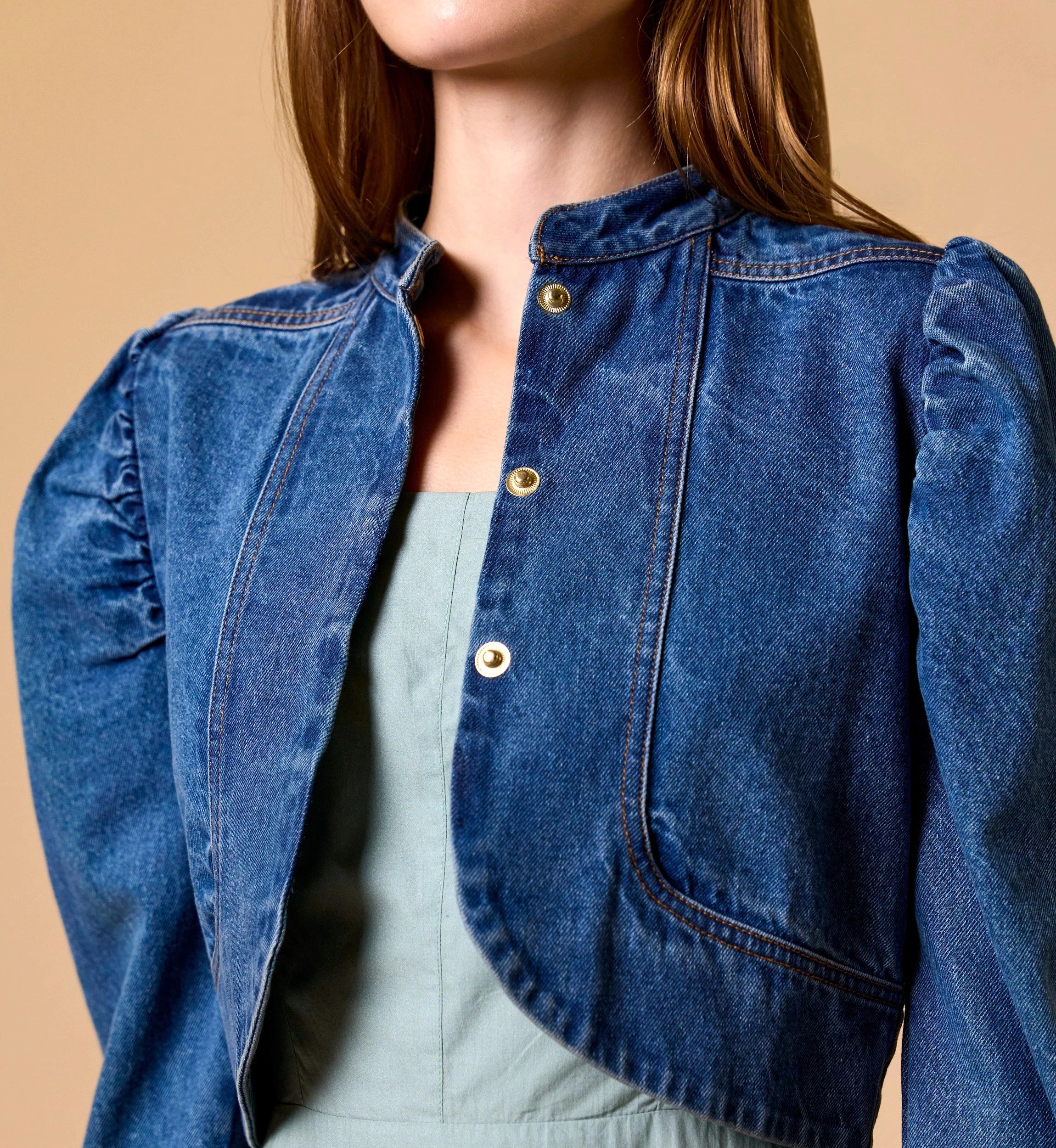 Woman Cleobella | Damien Denim Jacket blue denim jacket over a light green dress on a beige background