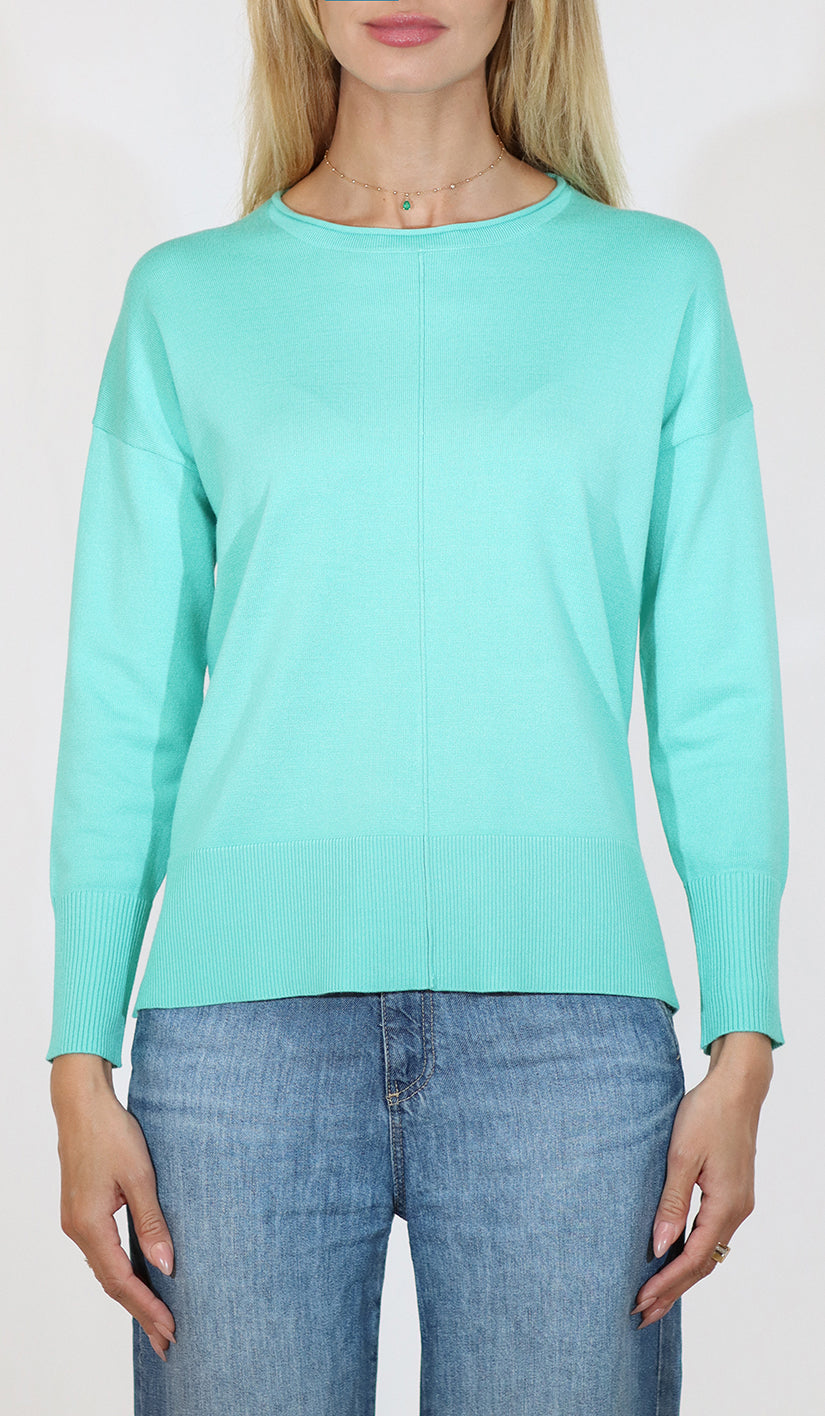 Person wearing a light blue sweater and jeans on a white background