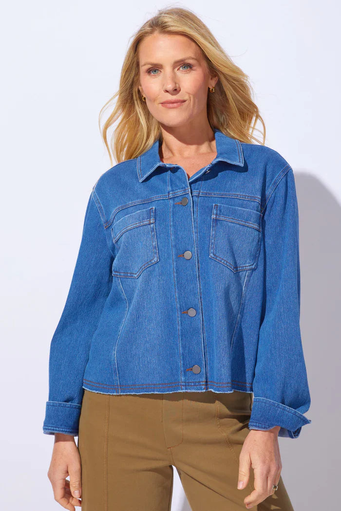 Blue wash ESCAPE BY HABITAT Denim Momentum Resort jacket displayed on a hanger, showcasing classic denim styling and stitching details.
