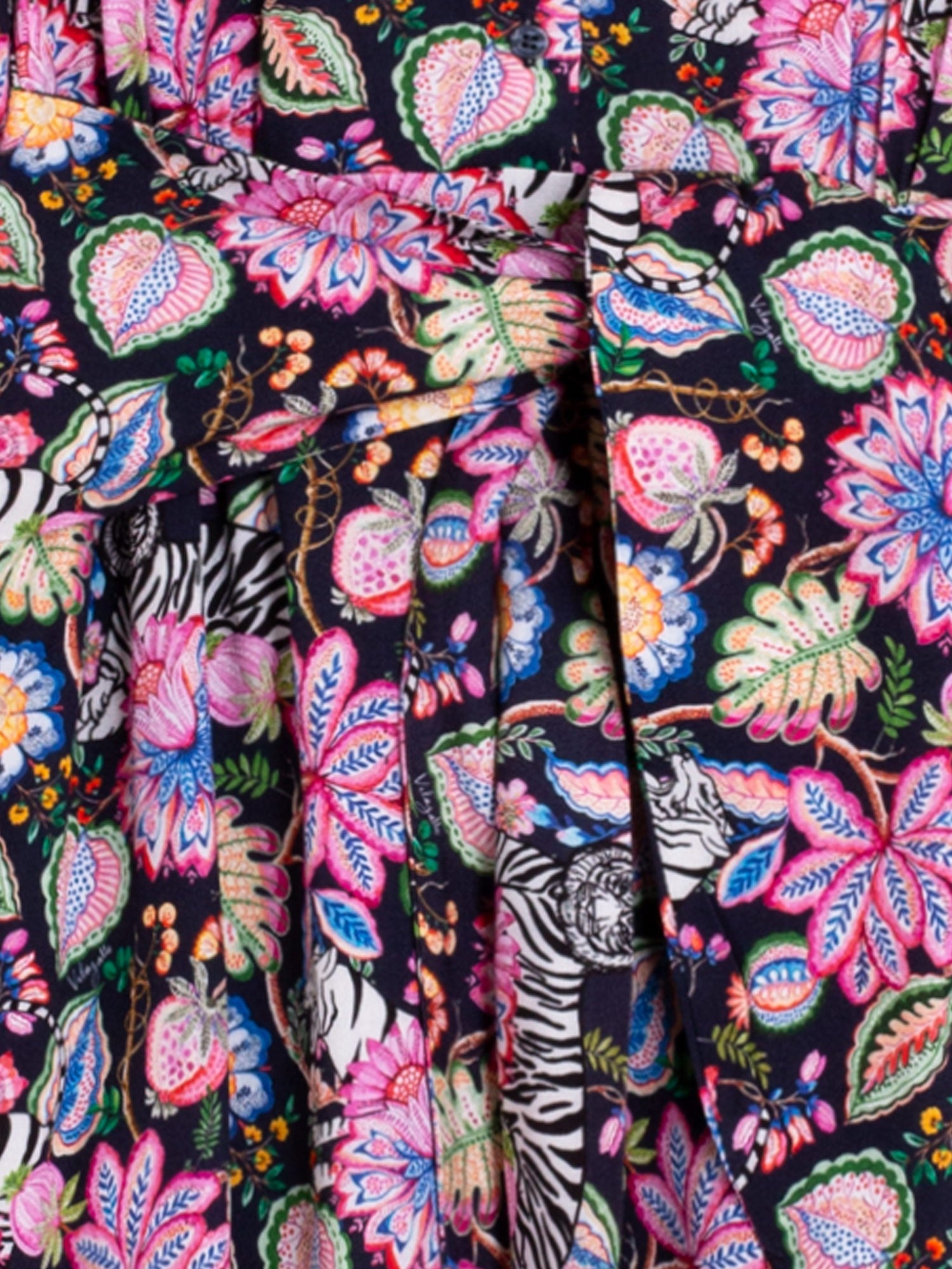 Close-up of a colorful floral and tiger pattern fabric.