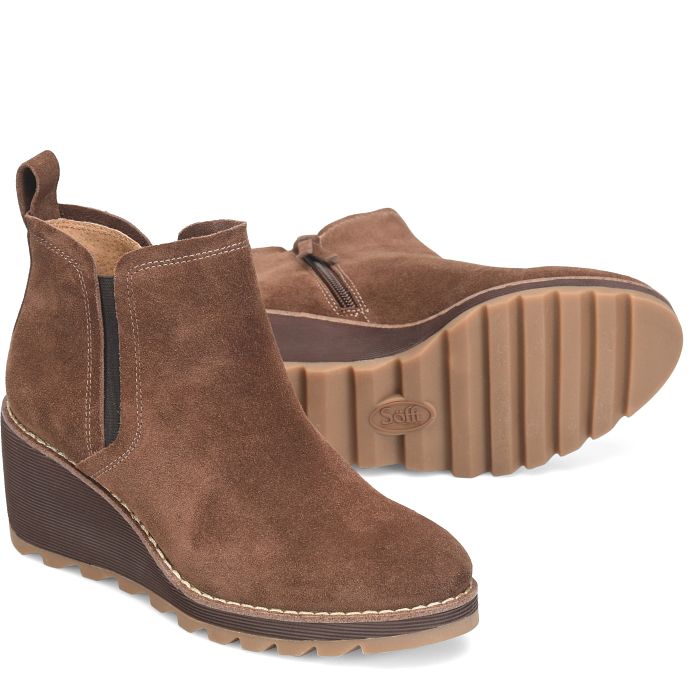 Brown suede wedge ankle boots on a white background