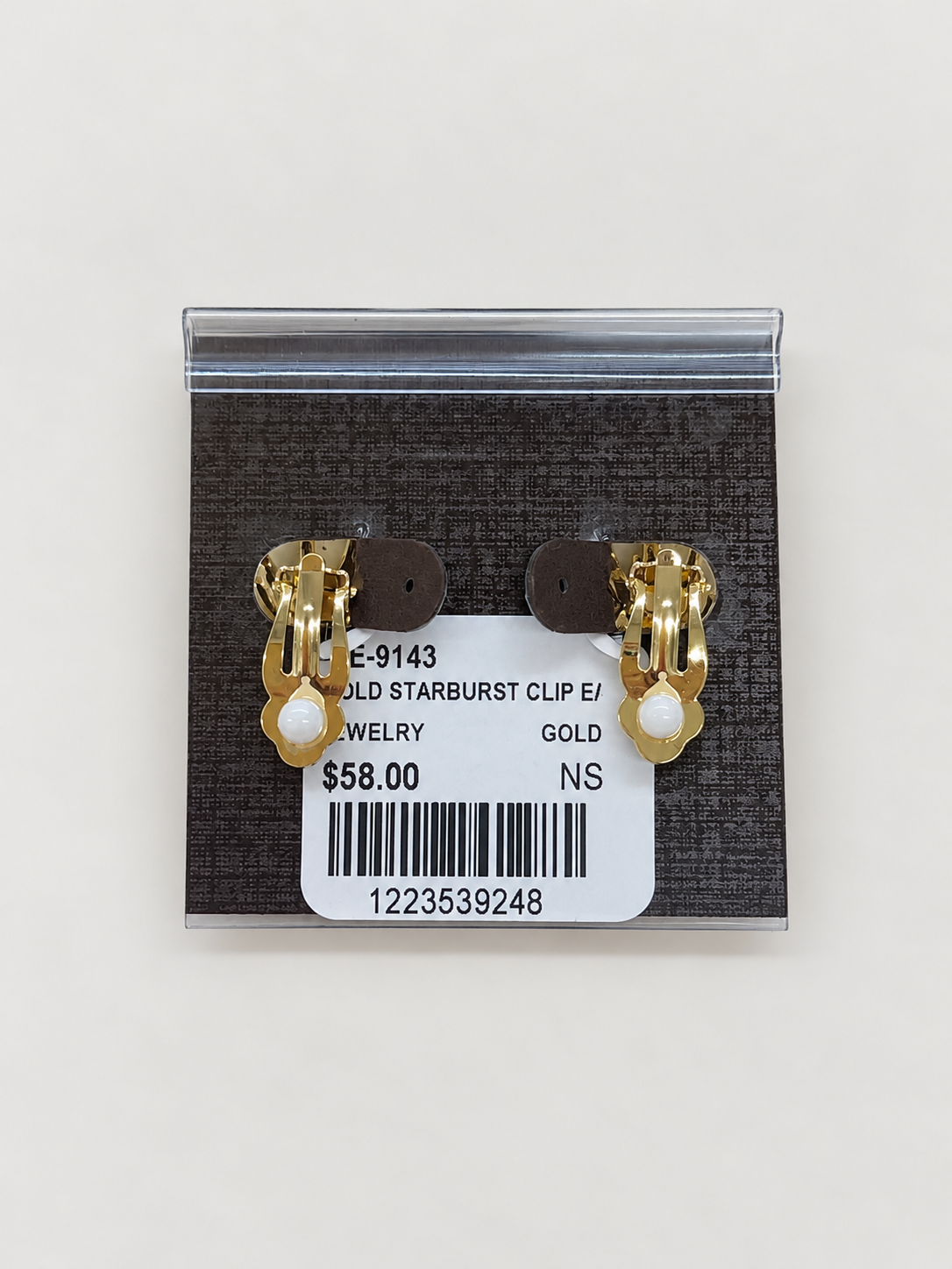 A pair of gold starburst stud clip-on earrings
