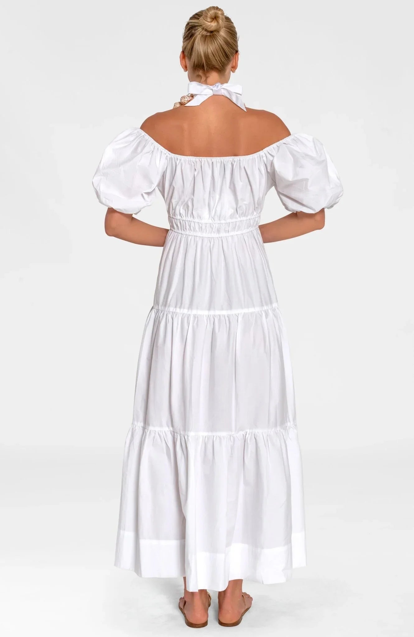Woman wearing a white dress on a white background