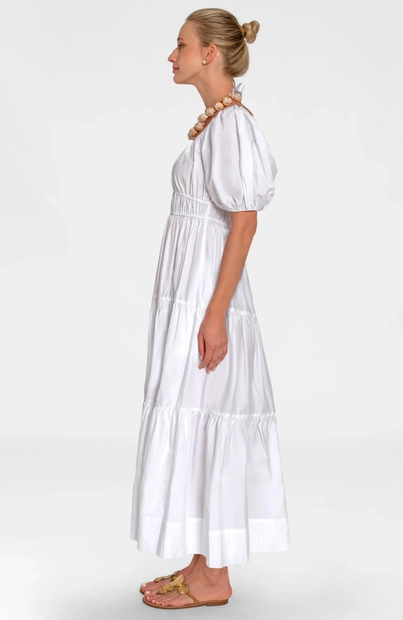 Woman wearing a white dress on a white background