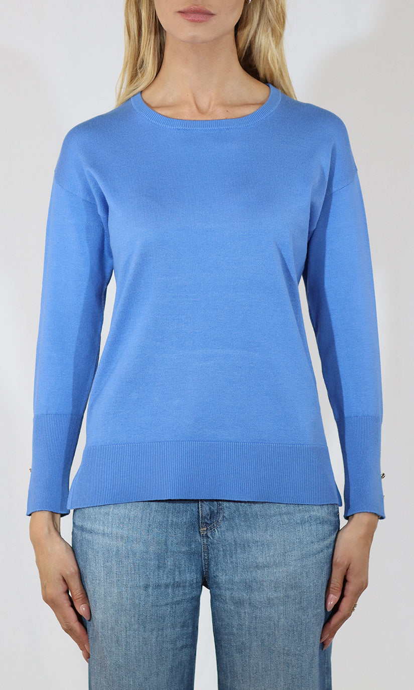 Person wearing a blue sweater and jeans on a white background