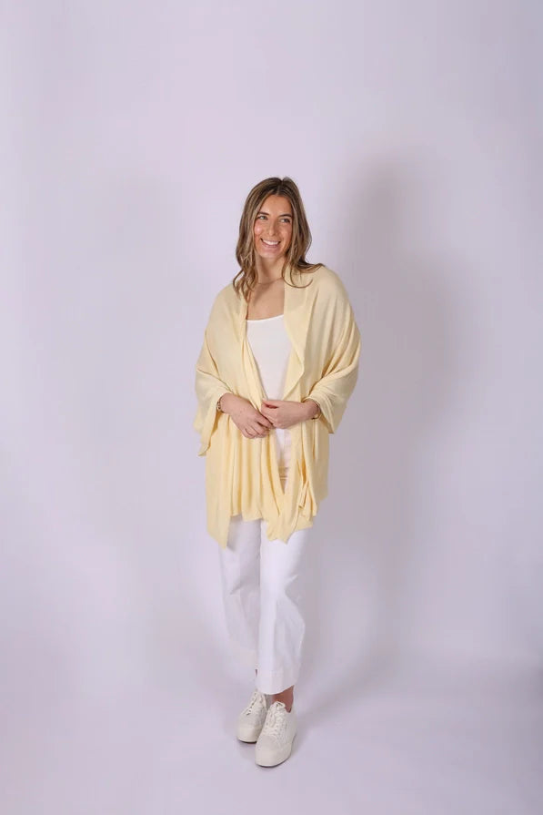 Woman wearing a light yellow Ari Bamboo Shawl Wrap