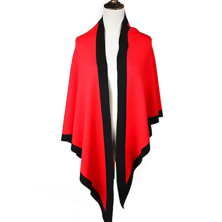 Red and black shawl on a mannequin against a white background