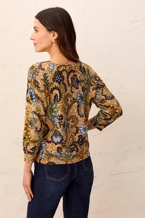 A woman wearing a long-sleeve crewneck top with an intricate paisley and floral pattern in gold, blue, green, and brown by tribal Soft Yarn Three-Quarter Sleeve Crewneck Sweater
