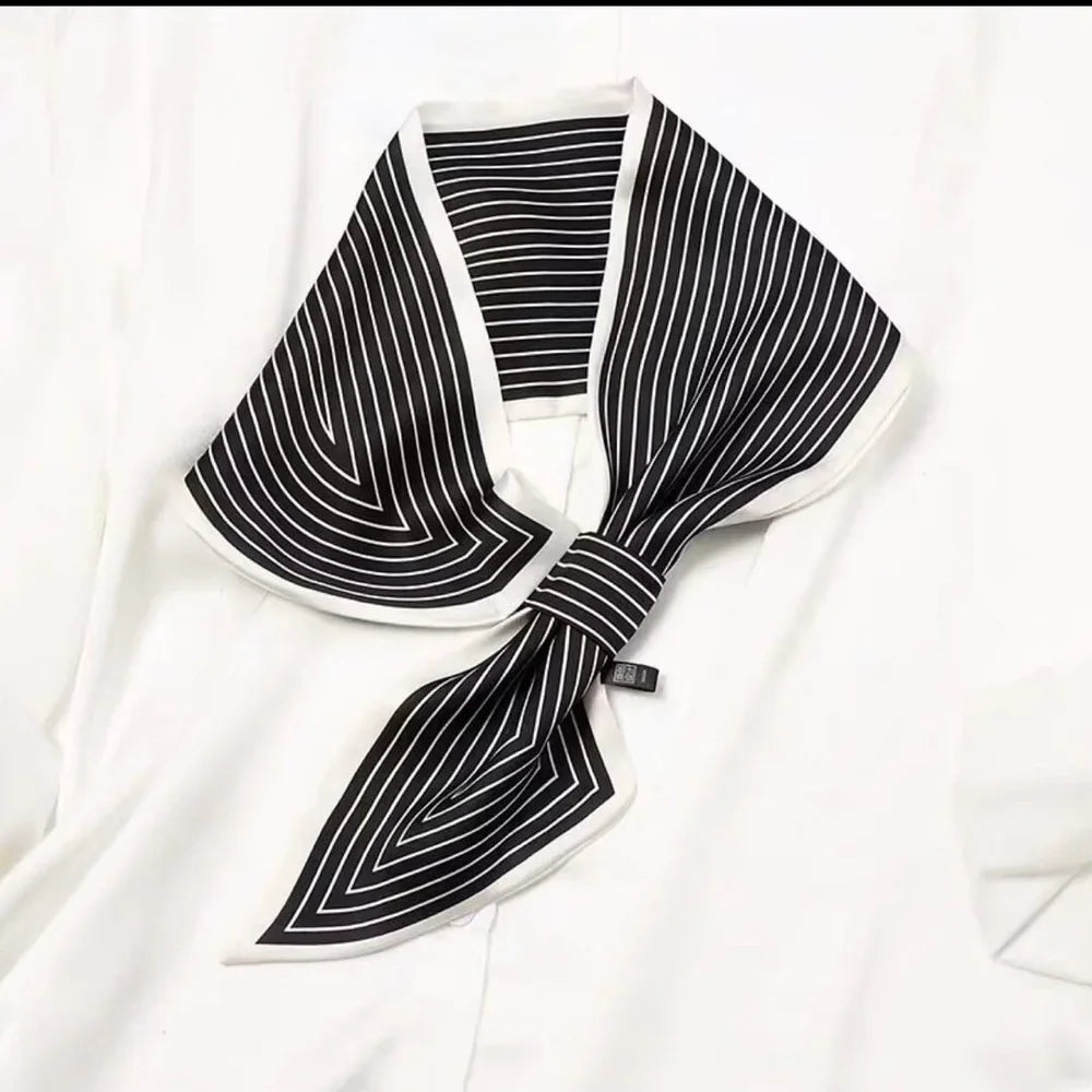 WINDING RIVER striped loop scarf with bold black and white pattern, lightweight and versatile accessory for stylish layering.