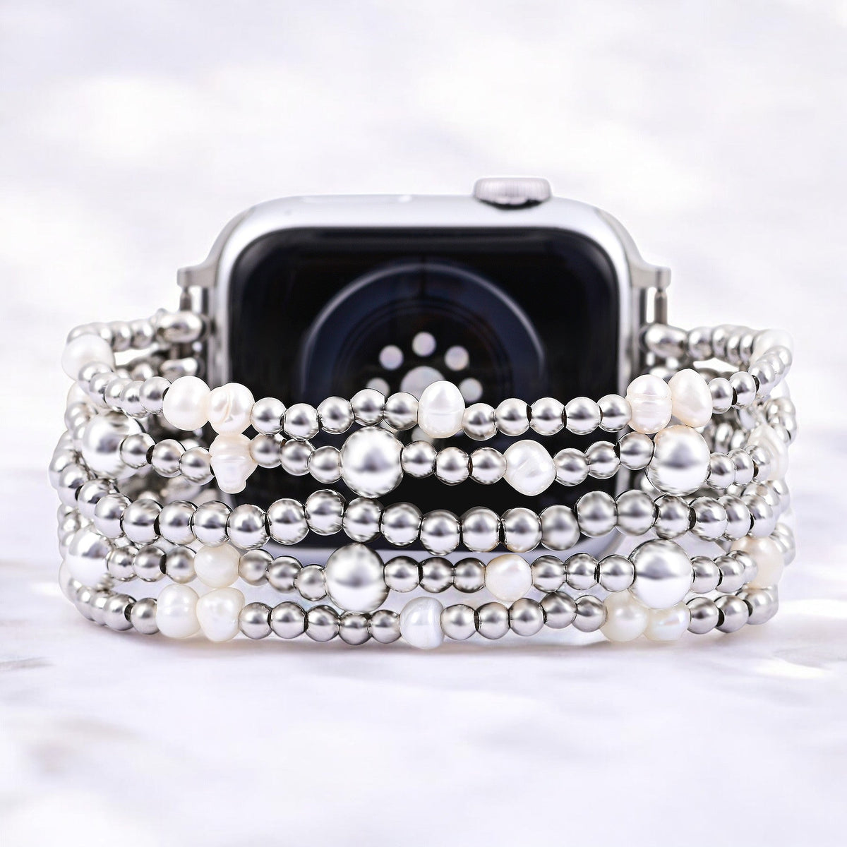 Cape Diablo shimmering pearl apple stretch bracelet with a sleek, metallic finish on a clear background