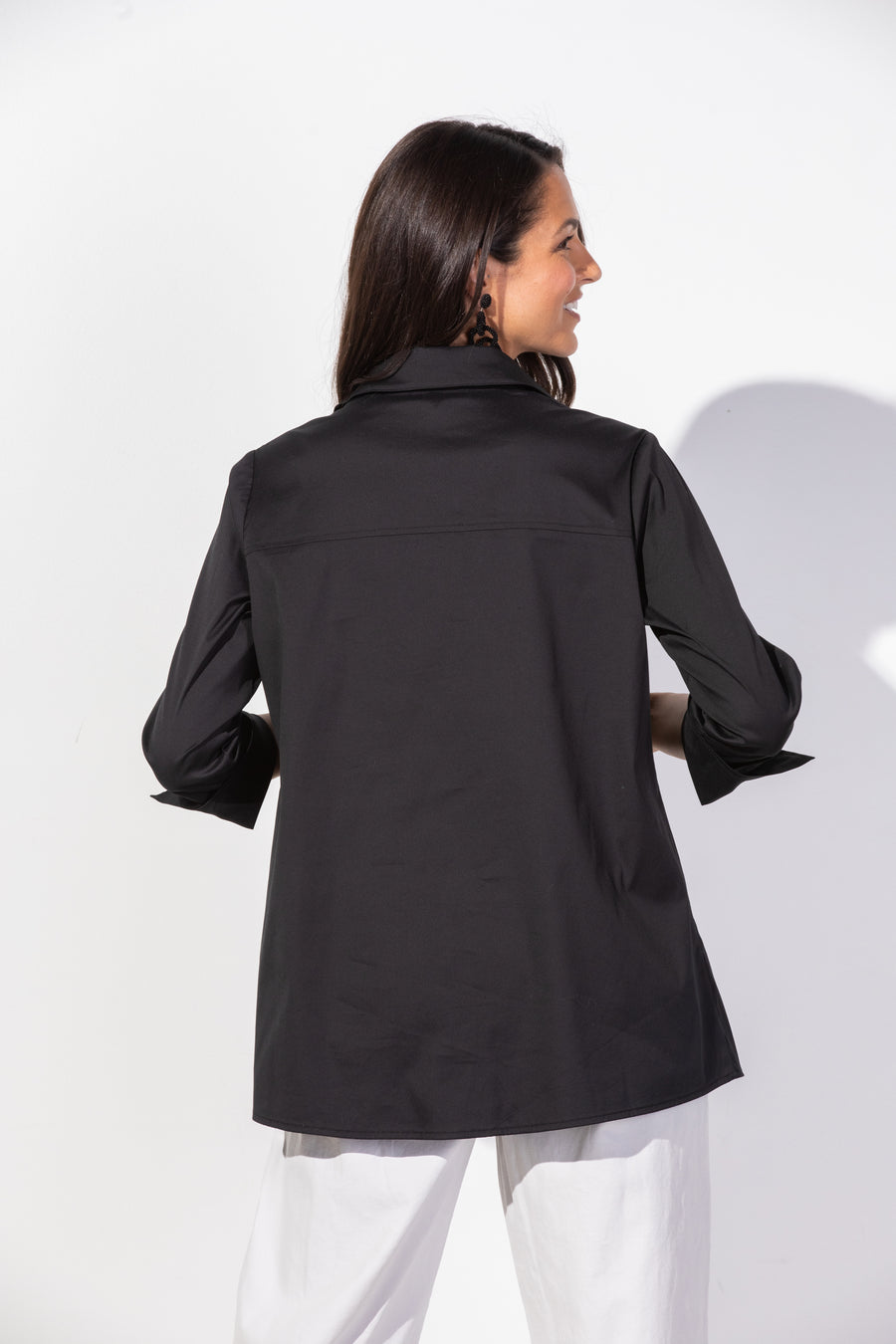 Black Habitat Perfect Travel Slim Hidden Placket Shirt for women, showcasing a sleek, fitted top with concealed front placket.