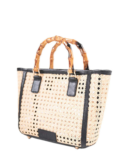 Woven handbag with black accents on a white background