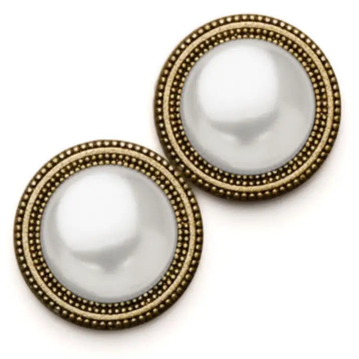 Close-up of a pearl button accessory by MAGNEBUTTON, showcasing a smooth, round pearl with a metal backing on a neutral background.