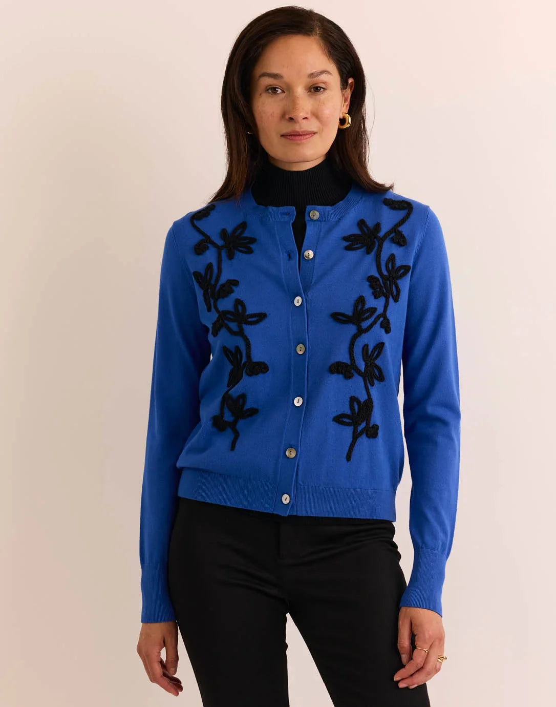Woman wearing a blue cardigan with black floral embroidery by  The H Edition Kaylee Long Sleeve Embroidery Cardigan Electric Blue