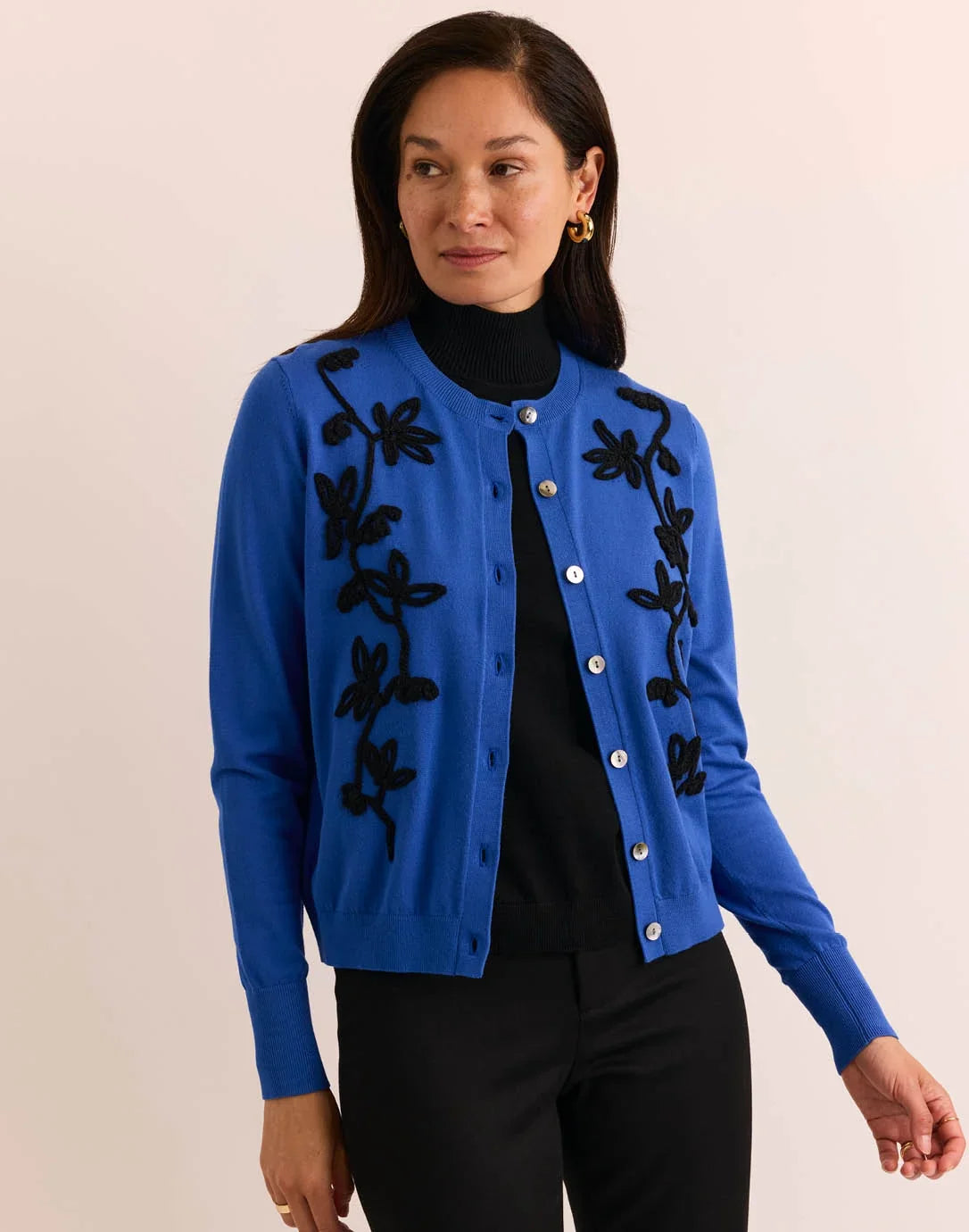 Woman wearing a blue cardigan with black floral embroidery by  The H Edition Kaylee Long Sleeve Embroidery Cardigan Electric Blue