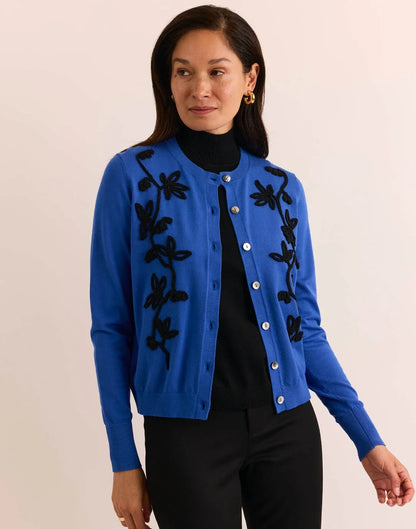 Woman wearing a blue cardigan with black floral embroidery by  The H Edition Kaylee Long Sleeve Embroidery Cardigan Electric Blue