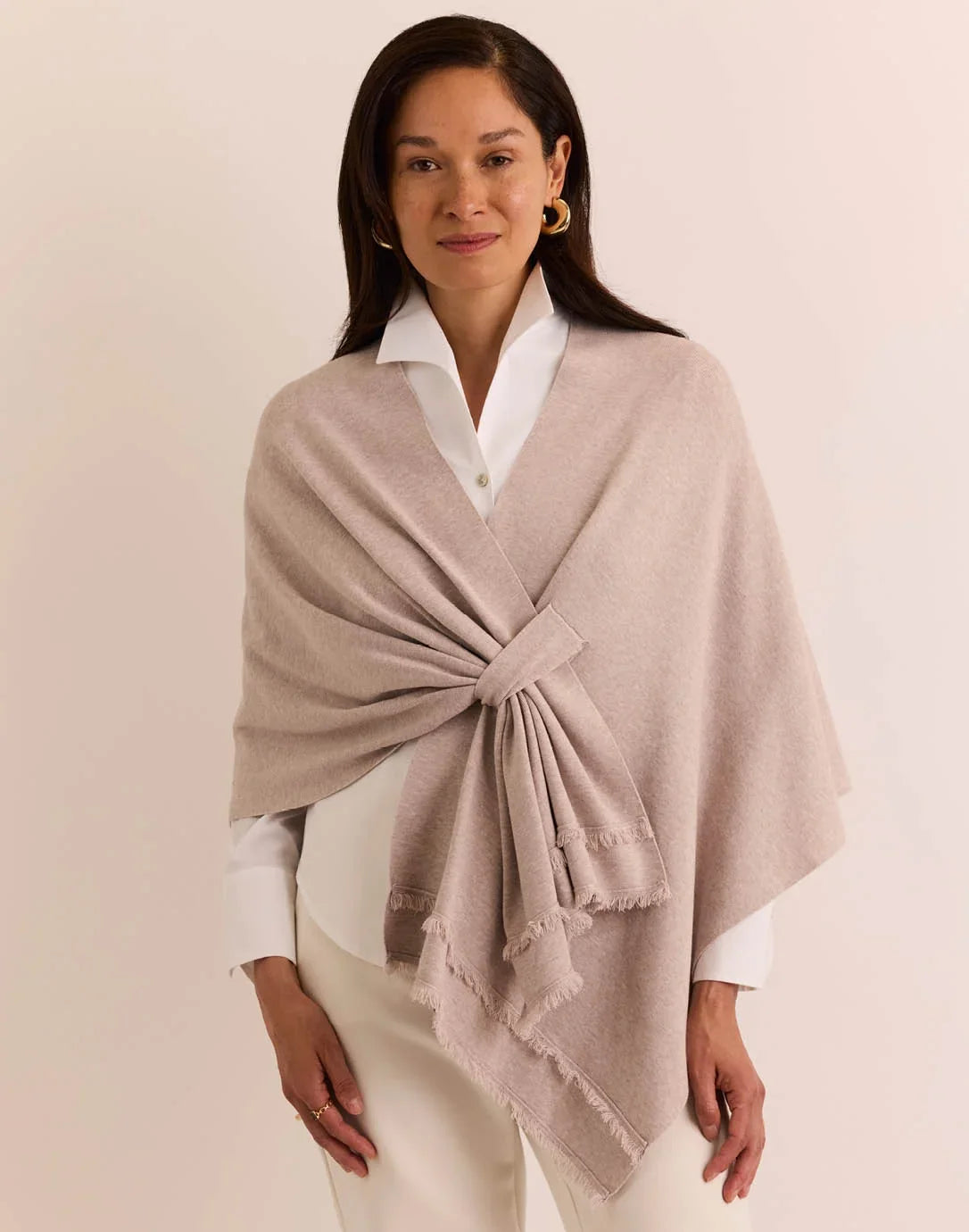 Woman wearing a beige shawl the h edition Mabel Tab Fringe Wrap stone heather
