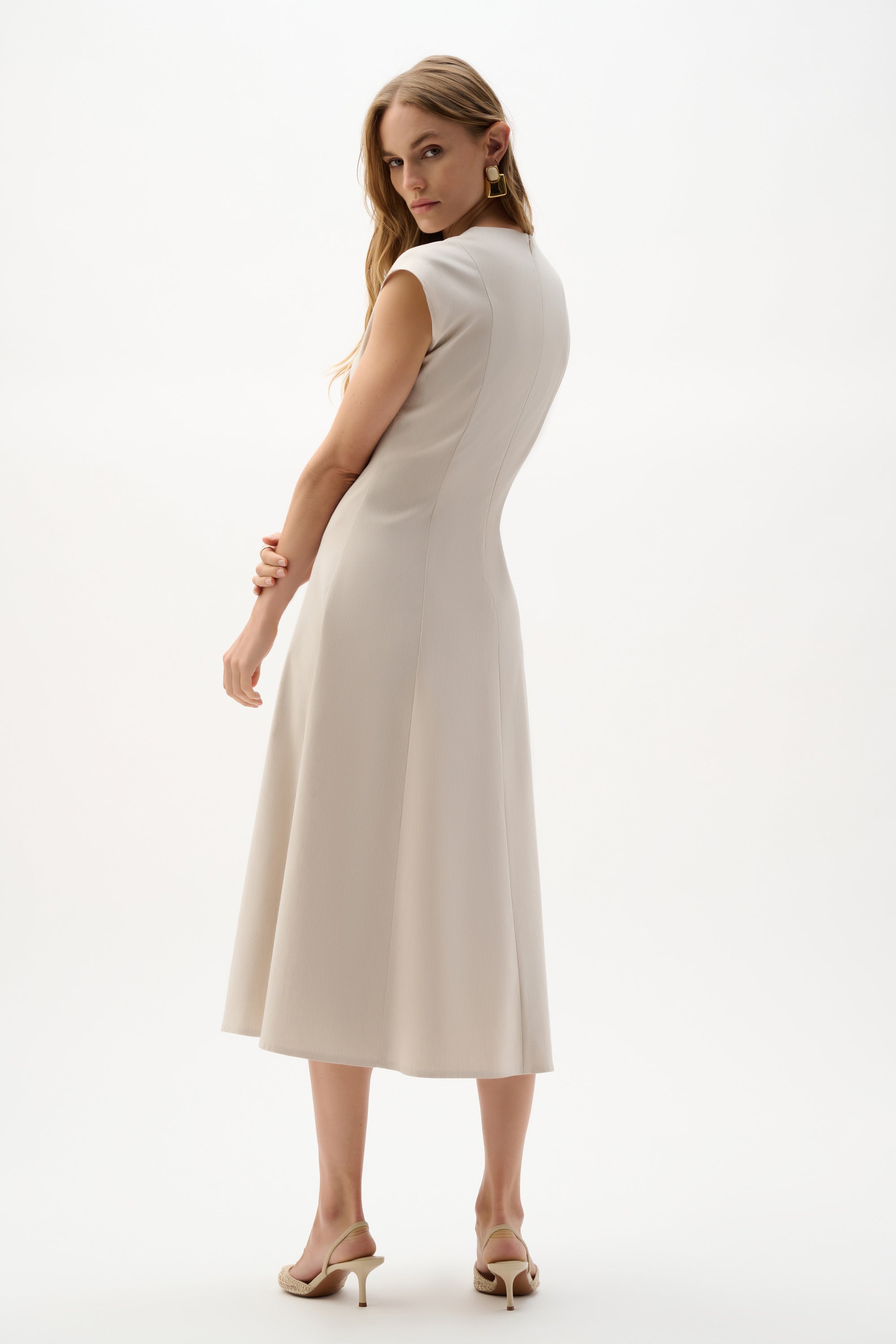 Joseph Ribkoff sleeveless fit and flare dress in vibrant fabric, showcasing a stylish and elegant silhouette.