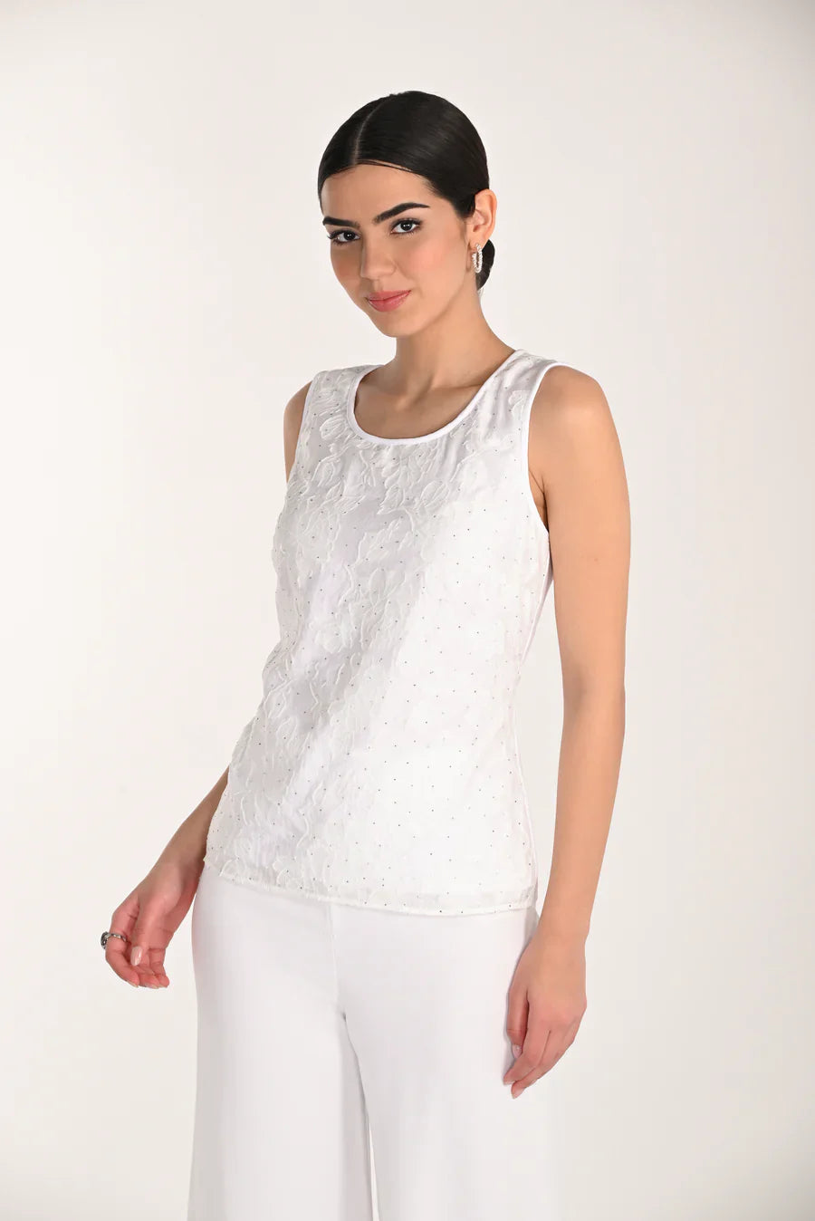 Elegant floral tank top by FRANK LYMAN featuring a fitted design with a colorful floral pattern.