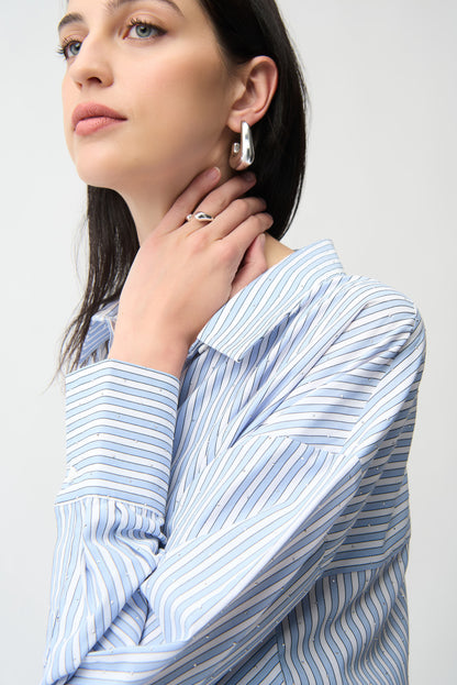 Joseph Ribkoff striped sparkly blouse, long-sleeve tops with shimmering fabric and bold stripe pattern, displayed on a hanger.
