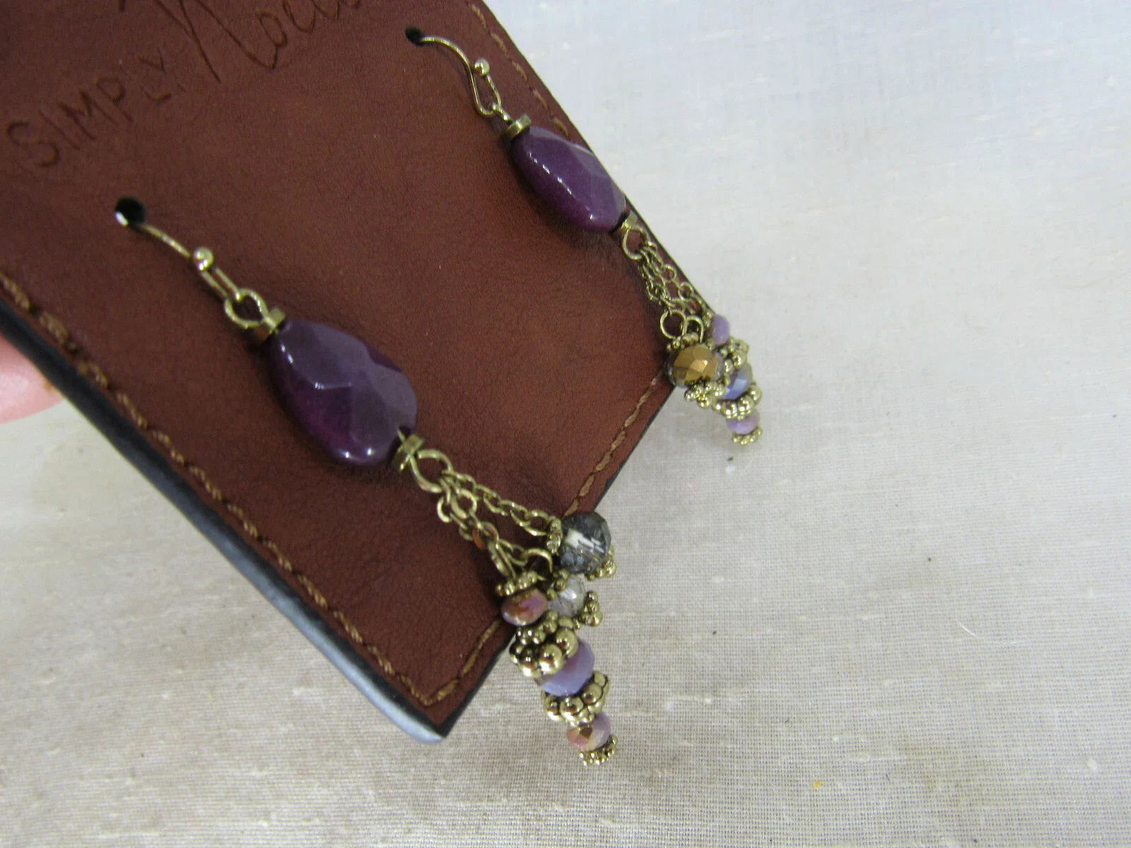 Natural stone earrings from SIMPLY NOELLE jewelry collection featuring smooth, polished stones with silver hooks.