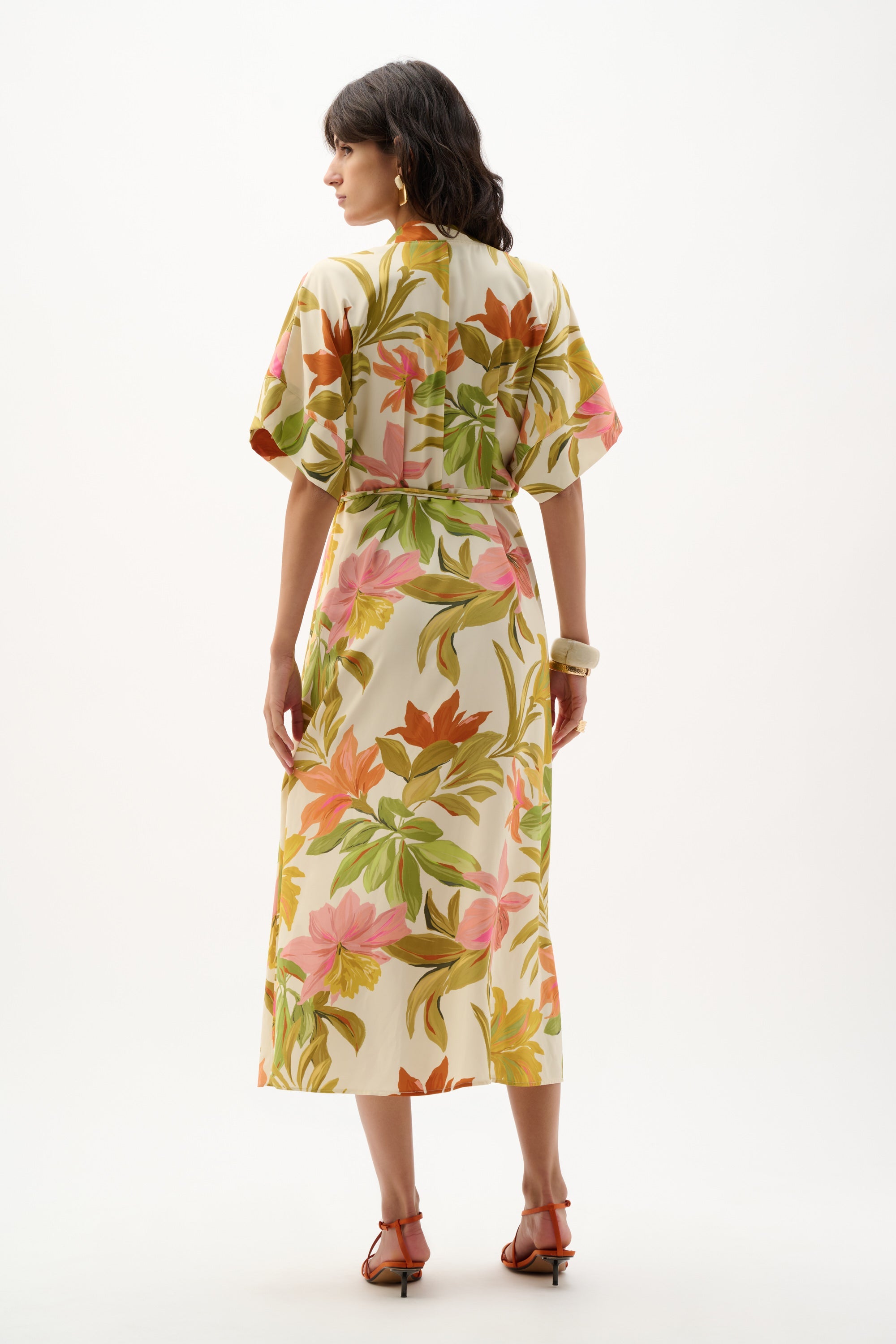 Joseph Ribkoff tropical print dress featuring vibrant floral patterns and a flowing silhouette on a model.