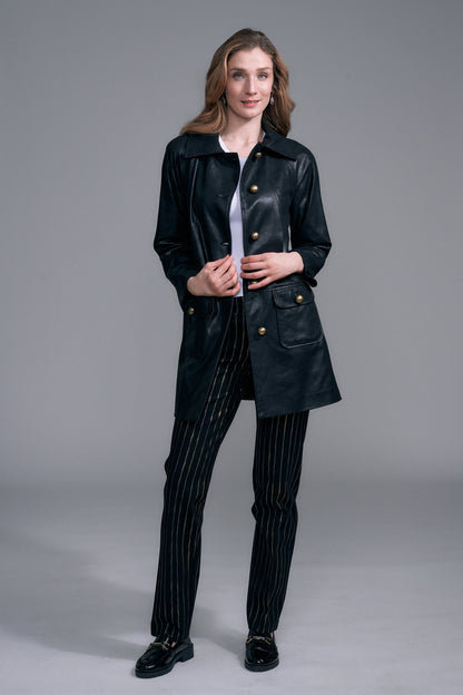 A woman modeling a black leather coat with gold-tone buttons by insight Vegan Leather Car Coat