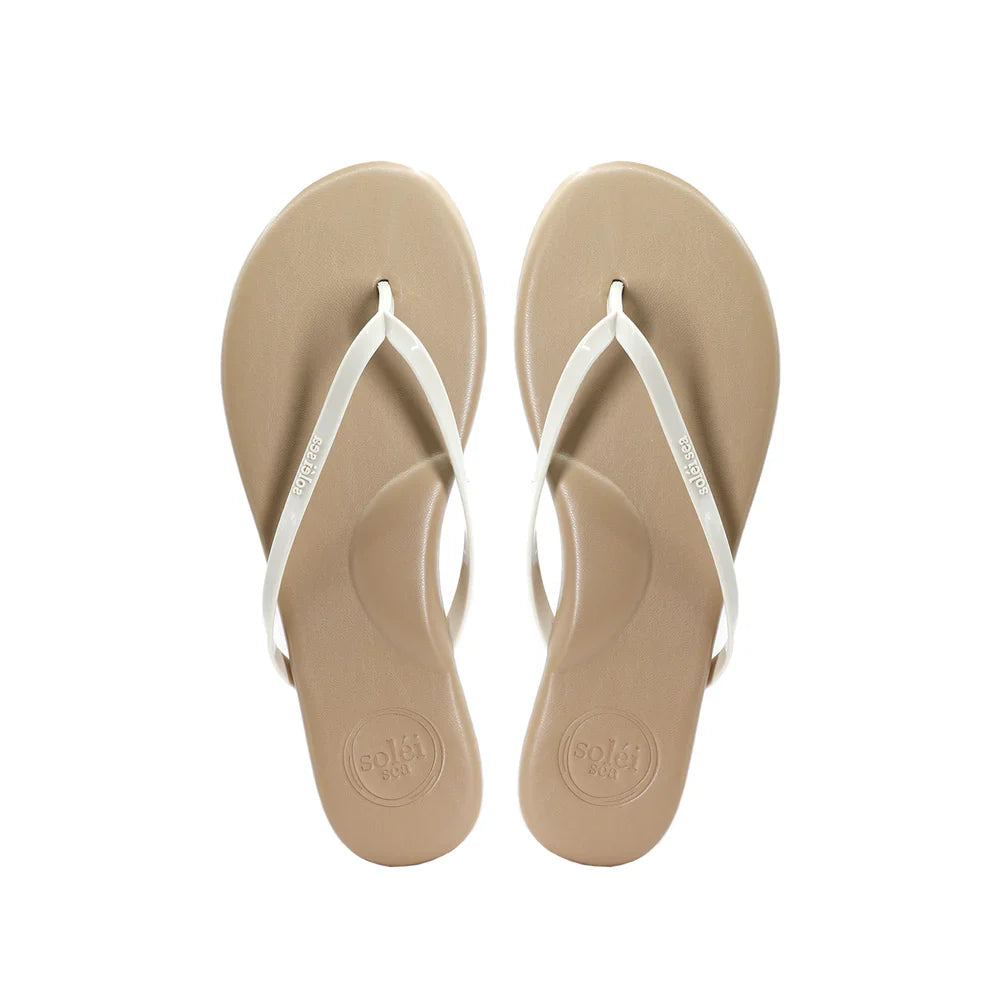 Pair of beige flip-flops with white straps on a white background