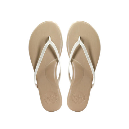 Pair of beige flip-flops with white straps on a white background