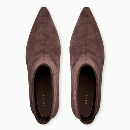 Pair of brown suede pointed-toe shoes on a white background