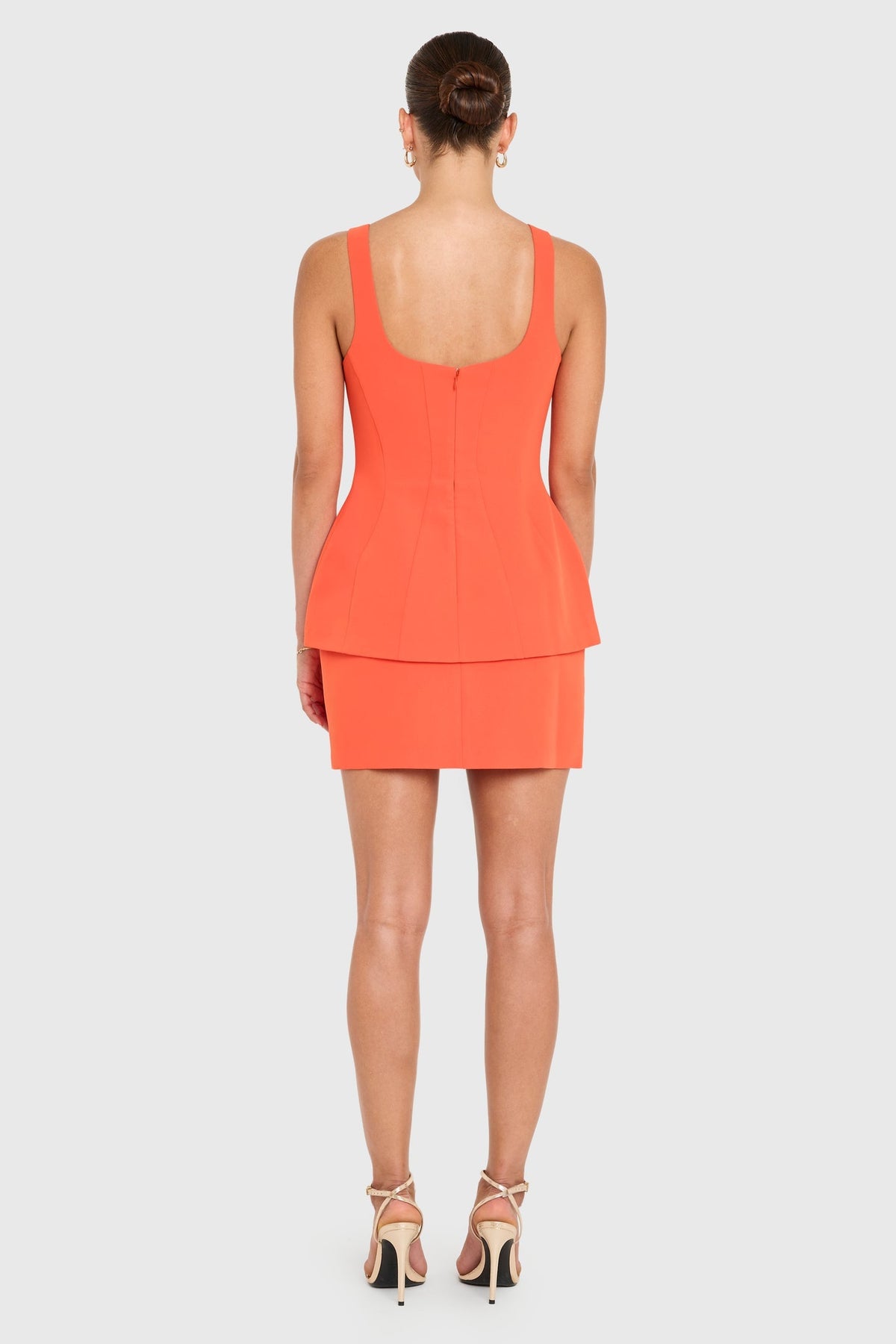 Amanda Uprichard Empire Dress in Mandarin color, flowing fabric with a fitted waist and elegant neckline, perfect for formal occasions.