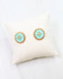 Caroline hill Kempsey Coin Stud Earring Turquoise, a pair of gold-tone stud earrings with oval turquoise blue centers and a floral motif.