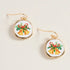 Earrings with Christmas-themed design on a beige background