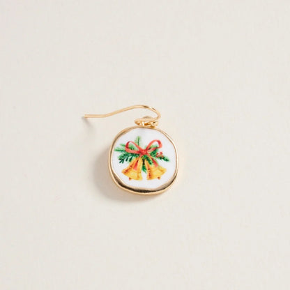 Embroidered earring with Christmas design on a beige background