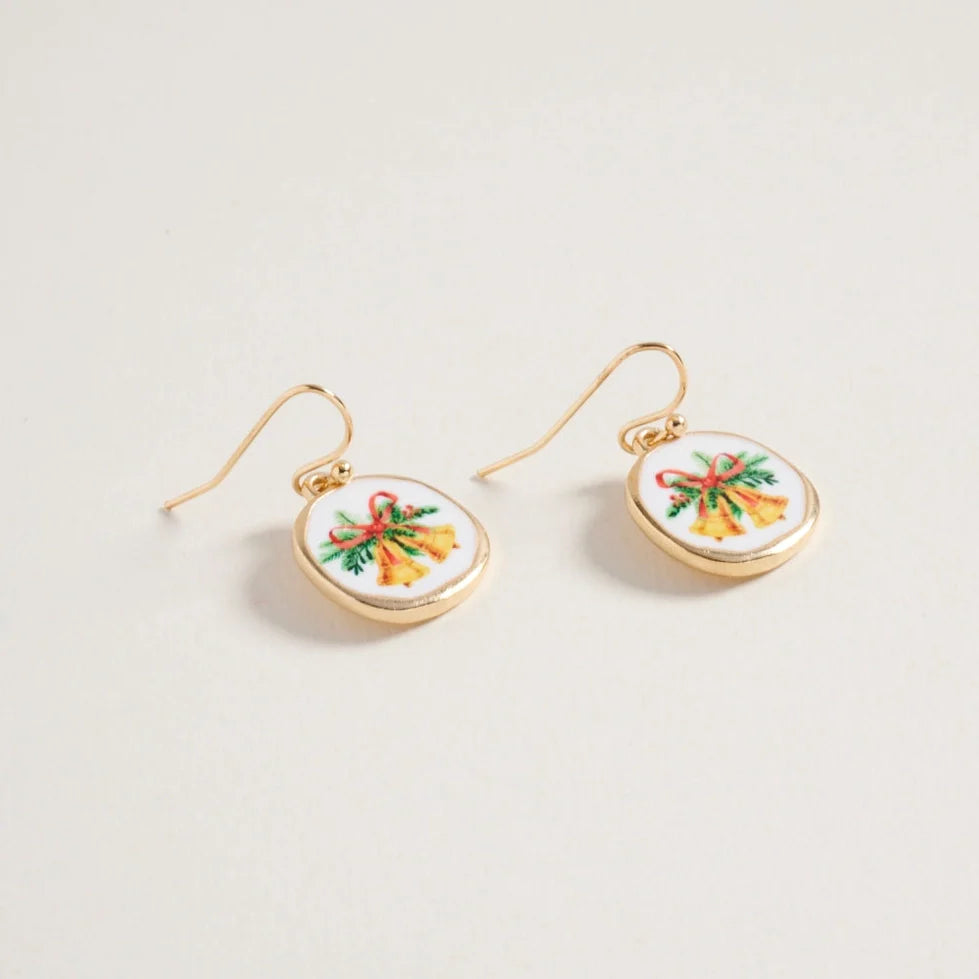Gold earrings with circular designs featuring colorful Christmas bells bows on a light gray background