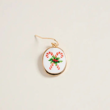 Earring with candy cane design on a beige background