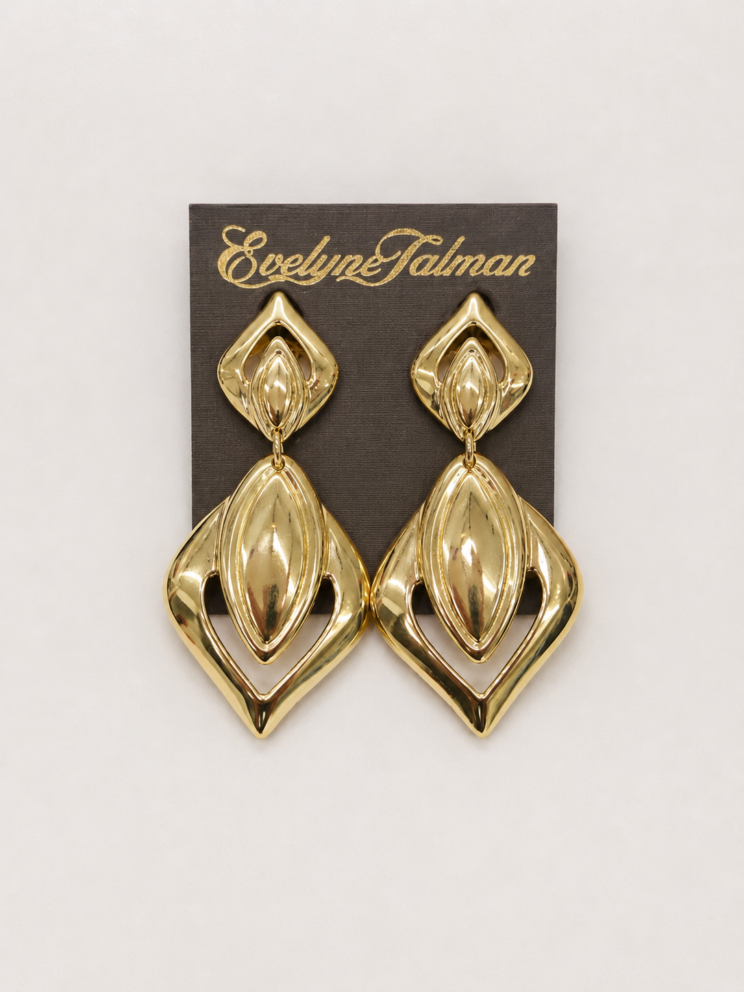 Cutout Geometric Drop Clip-on Earrings pair of gold statement drop earrings with a geometric, layered marquise-like design