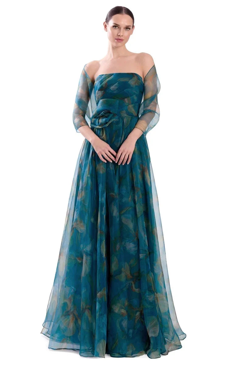 A woman modeling a strapless off-the-shoulder floor-length gown in teal blue-green sheer fabric with a subtle tonal floral pattern. Draped 3D Flower Strapless Gown - Alexander by Daymor 3304F26