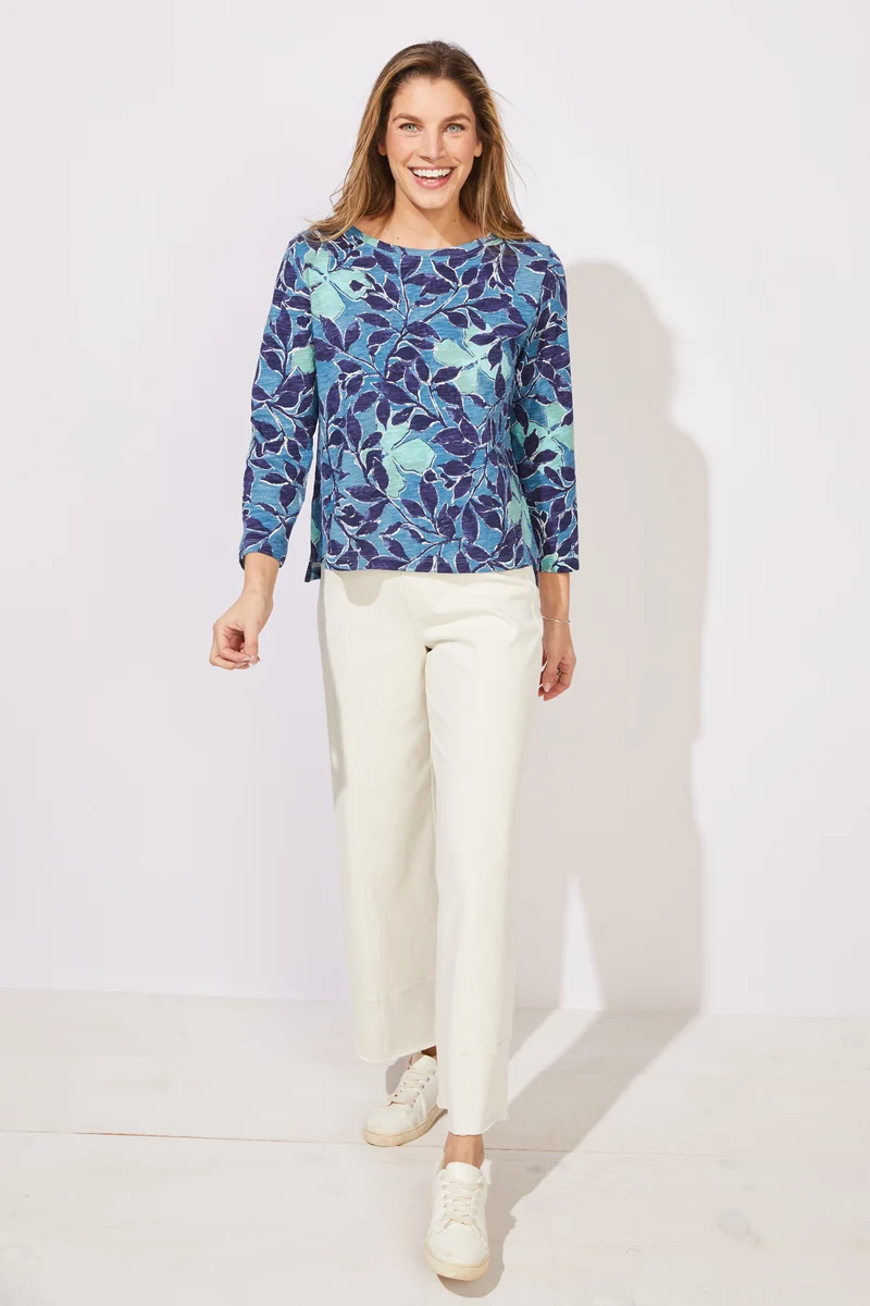 Woman wearing a blue floral patterned top ESCAPE BY HABITAT  FOLIAGE FLORAL COTTON BOXY TEE - 12125 Color Harbor