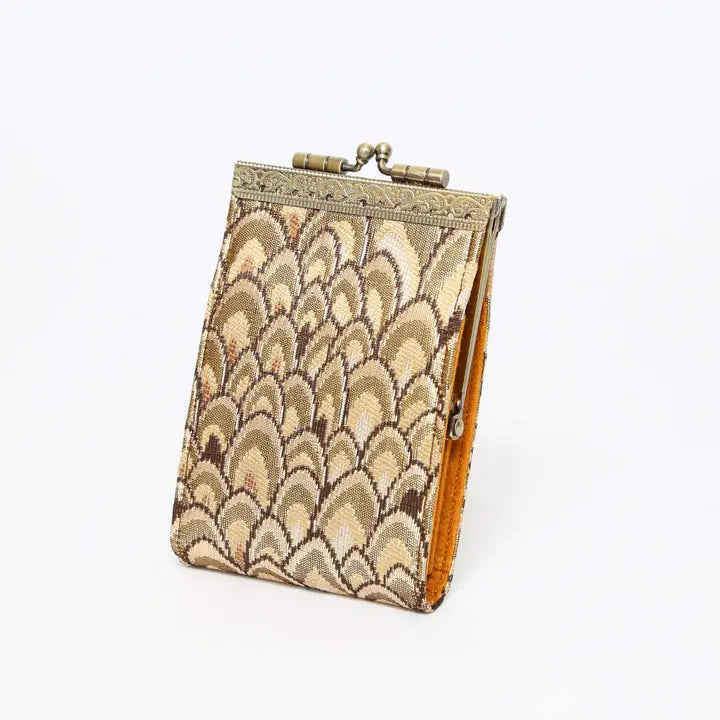 Decorative clutch with a scalloped pattern on a white background