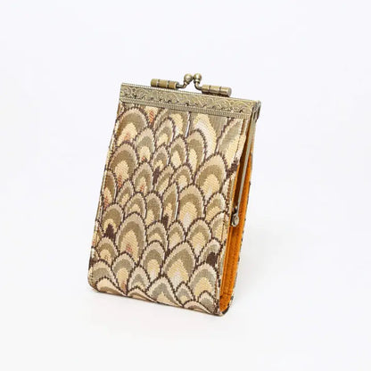Decorative clutch with a scalloped pattern on a white background
