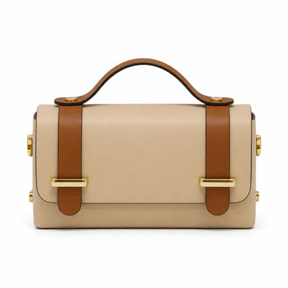 A structured beige leather handbag with a top handle, brown leather strap details, and gold-tone hardware by German Fuentes Handbags Top-Handle Crossbody Bag IVORY CAMEL
