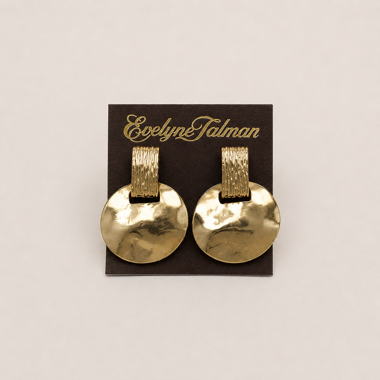 Gold Hammered Disc Drop Clip-on Earrings a pair of gold-tone disc earrings with textured bands.